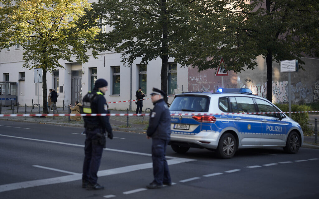 German police officers stand guard in front of the building complex of the Kahal Adass Jisroel community after it was attacked by two incendiary devices, in the center of Berlin, Germany, October 18, 2023. (AP Photo/Markus Schreiber)