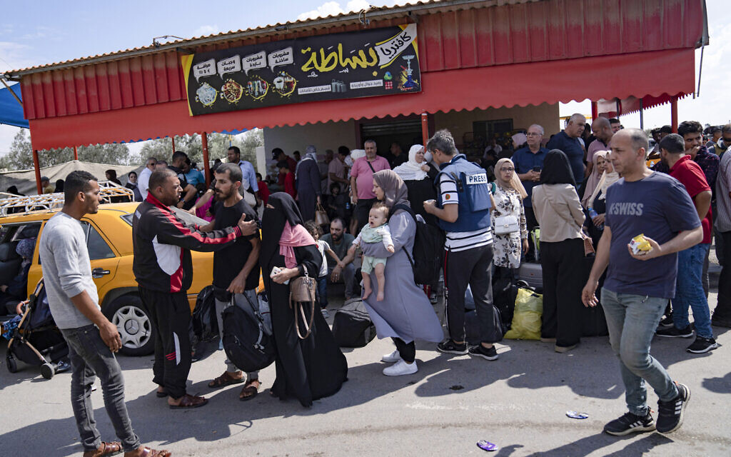 Palestinians wait to cross into Egypt at the Rafah border crossing in the Gaza Strip, October 16, 2023. (AP Photo/Fatima Shbair)