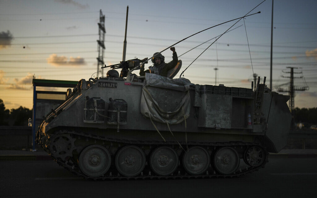 An Israel soldier gestures to passers-by as he drives a military vehicle near the border between Israel and Gaza Strip, October 19, 2023. (AP Photo/Francisco Seco)