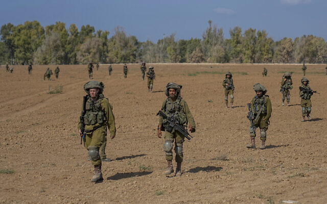 Israeli soldiers patrol next to communities near the Israeli-Gaza border, southern Israel, October 20, 2023. (AP Photo/Ohad Zwigenberg)