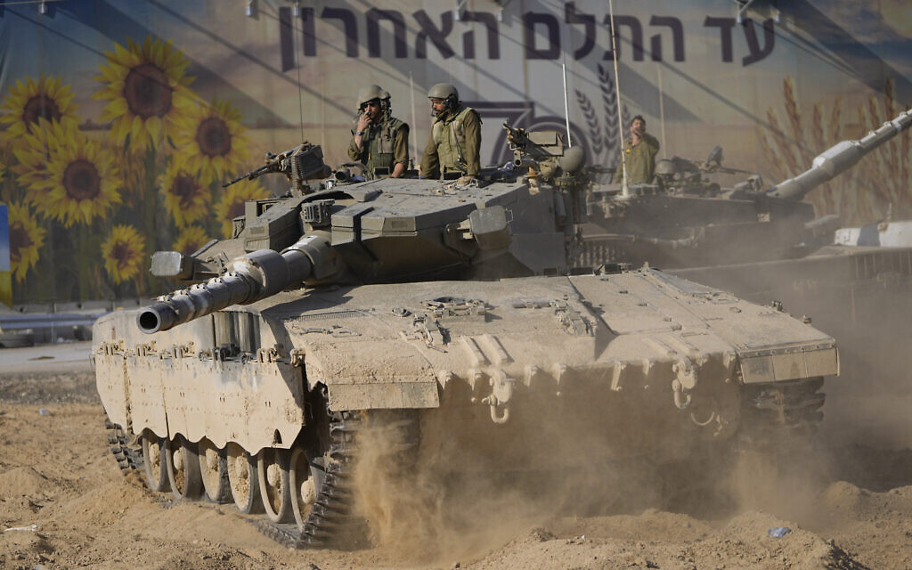 Israeli soldiers move a tank at a staging area near the border with Gaza Strip, in southern Israel on October 15, 2023. (AP Photo/Ohad Zwigenberg)