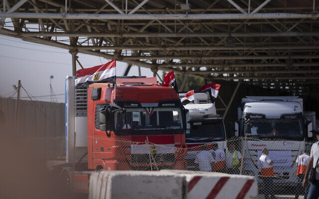 Trucks carrying humanitarian aid line up on the Egyptian side of the border with the Gaza Strip in Rafah on Oct. 21, 2023. (AP Photo/Fatima Shbair)
