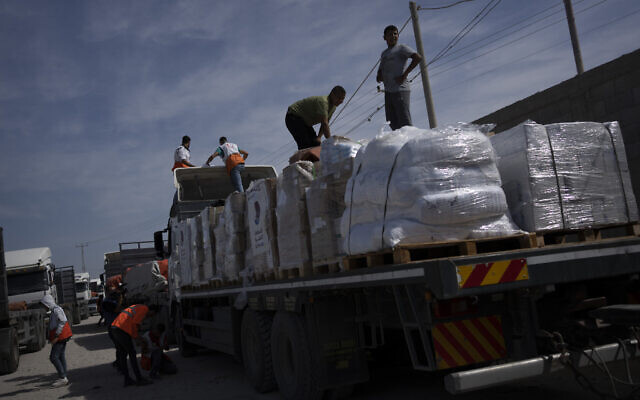 Trucks with humanitarian aid for the Gaza Strip enter from Egypt in Rafah on Saturday, Oct. 21, 2023. (AP/Fatima Shbair)