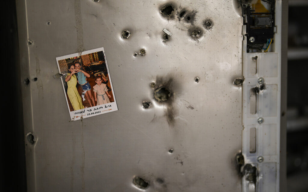A photo hangs on a refrigerator next to bullet holes in a house at Kibbutz Kissufim in southern Israel, October 21, 2023, after it was targeted in the Gaza-ruling Hamas terror group's deadly onslaught on October 7. (AP Photo/Francisco Seco)