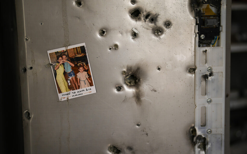 A photo hangs on a fridge next to bullet 
holes in a house at Kibbutz Kissufim in southern Israel, Saturday, Oct. 21, 2023. (AP/Francisco Seco)