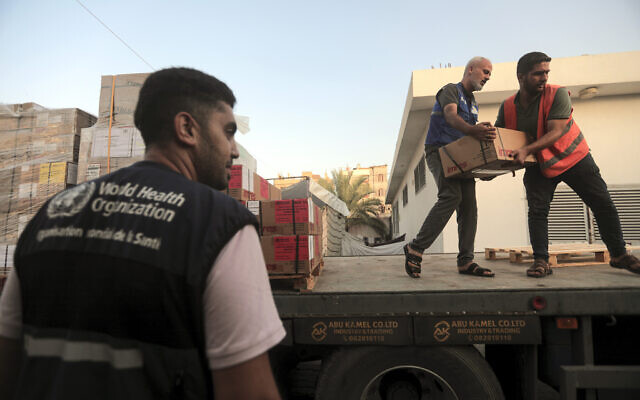 Palestinians unload boxes of medicine from a truck arrived at Nasser Medical Complex, as part of the aid batch that entered in to the Gaza strip from Rafah crossing Sunday, in town of Khan Younis, southern Gaza Strip, Monday, Oct. 23, 2023. (AP Photo/Mohammed Dahman)