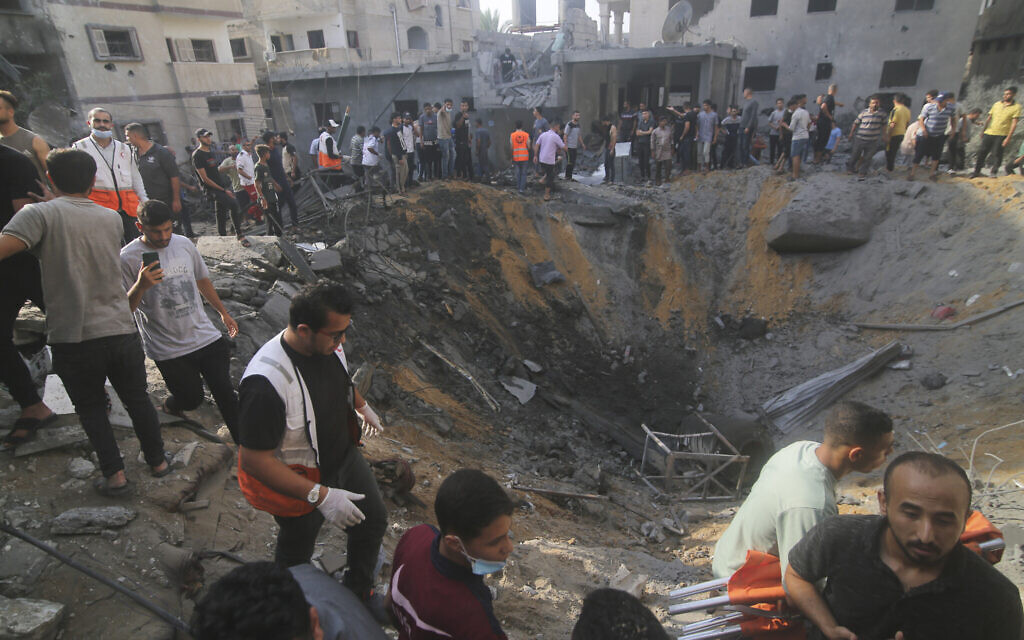 Palestinians look for survivors after an Israeli strike on the Zaroub family house in Rafah, Gaza Strip, Oct.24, 2023. (AP Photo/Hatem Ali)