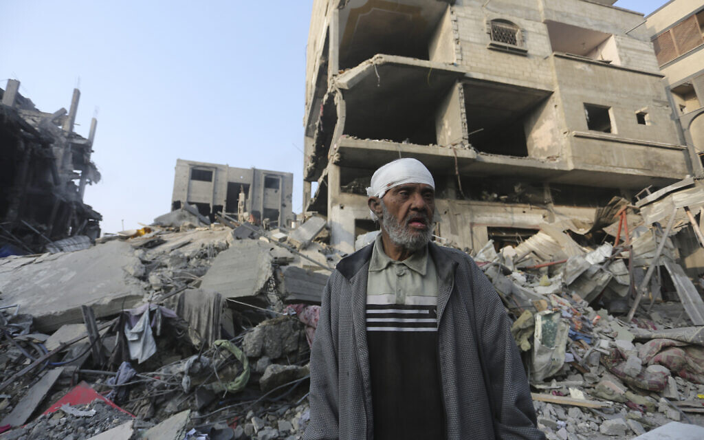 A Palestinian stands outside the building destroyed in an Israeli airstrike in the Gaza Strip in Rafah, Wednesday, Oct 25, 2023. (AP Photo/Hatem Ali)