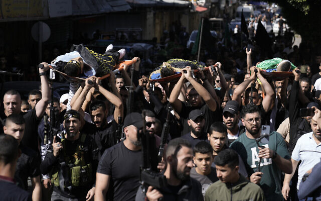 Palestinians carry bodies of terrorists killed in an Israeli airstrike on the refugee camp in Jenin, West Bank, during their funeral Wednesday, Oct. 25, 2023. (AP Photo/Majdi Mohammed)
