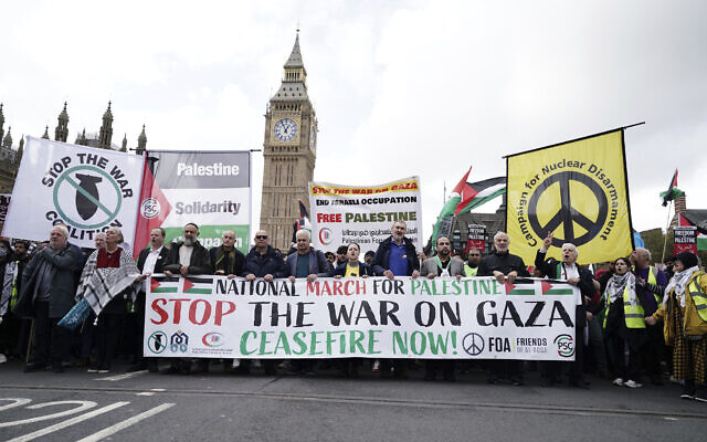 Protesters hold a banner during a pro-Palestinian march, in central London, October 28, 2023. (Jordan Pettitt/PA via AP)