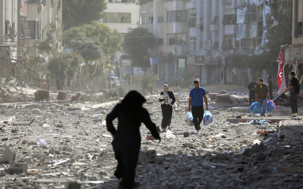 Palestinians leave their homes following Israeli bombardment on Gaza City, October 30, 2023. (Abed Khaled/AP)