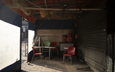Tables and chairs at a restaurant that has closed in Sderot, Oct. 25, 2023 (AP Photo/Maya Alleruzzo)