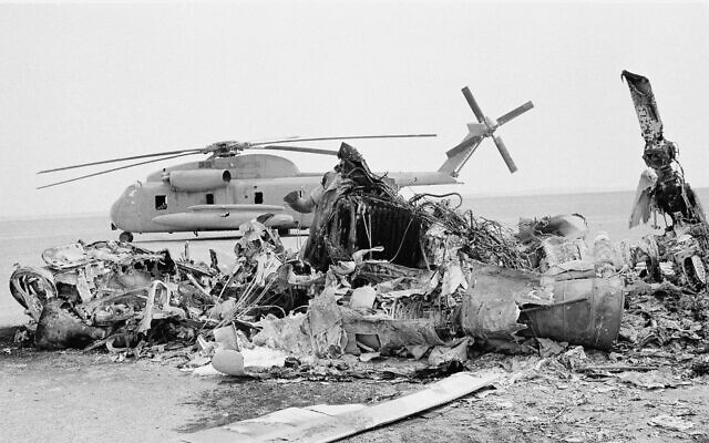 Remains of a burned-out US helicopter lies in front of abandoned chopper in the eastern desert region of Iran, April 27, 1980, one day after an abortive American commando raid to free the US Embassy hostages. (AP Photo)