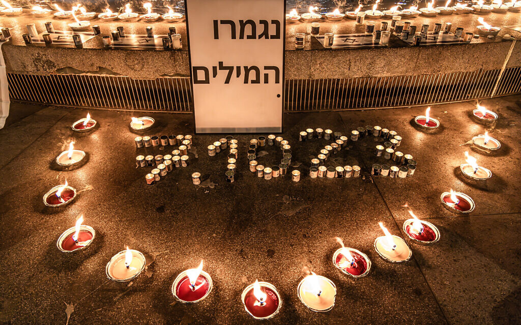 A scene from the 1300 Candle Vigil in Dizengoff Square in Tel Aviv, on October 12, 2023. The sign reads 'No more words.' (Eli Katzoff)