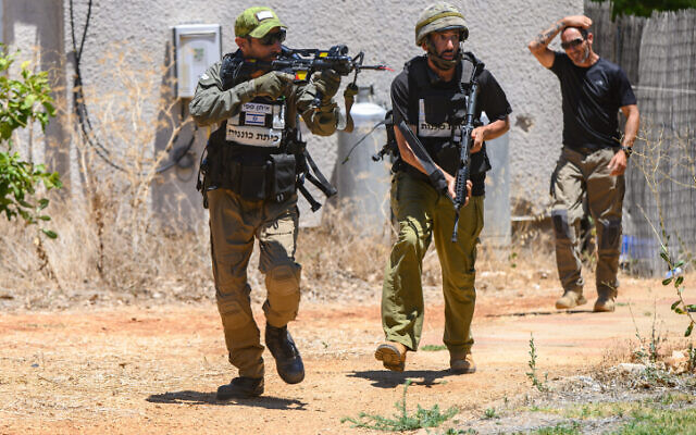 Members of the civilian security team of Kibbutz Malkia in northern Israel close to the Lebanese border are seen during a drill simulating the Infiltration of a terrorist into the kibbutz, July 19, 2023. (Ayal Margolin/Flash90)