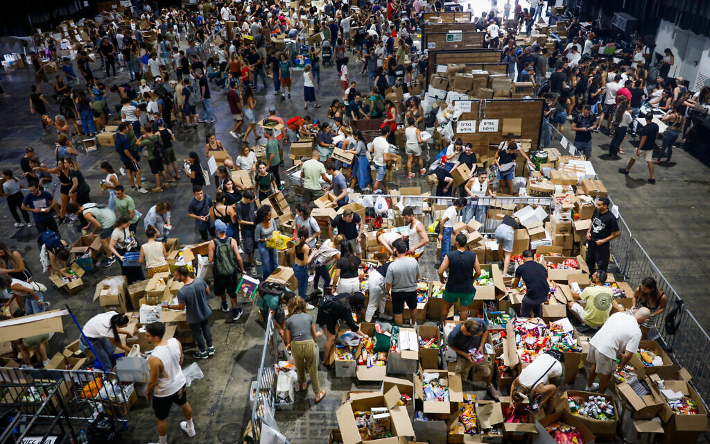 Israelis pack up donations of food and other necessities for Israeli soldiers and civilians in the south, in Tel Aviv, on October 9, 2023. (Miriam Alster/Flash90)