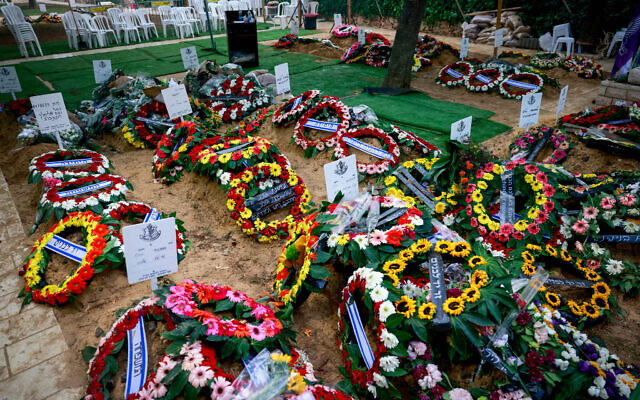 Flowers on fresh graves of Israeli soldiers killed in fighting with Gaza terror groups, at Mt Herzl military cemetery in Jerusalem. October 12, 2023 (Chaim Goldberg/FLASH90)