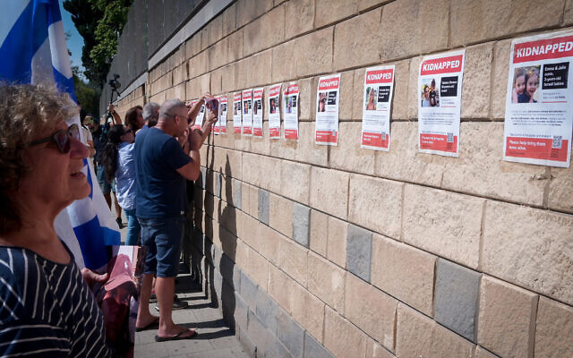 Posters of those held hostage by terrorists in Gaza are glued to the wall outside the Defense Ministry in Tel Aviv, October 14, 2023 (Avshalom Sassoni/FLASH90)