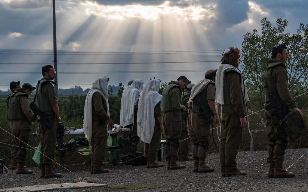Israeli soldiers pray at a staging area near the border with Lebanon, northern Israel, October 15, 2023. (Ayal Margolin/Flash90)