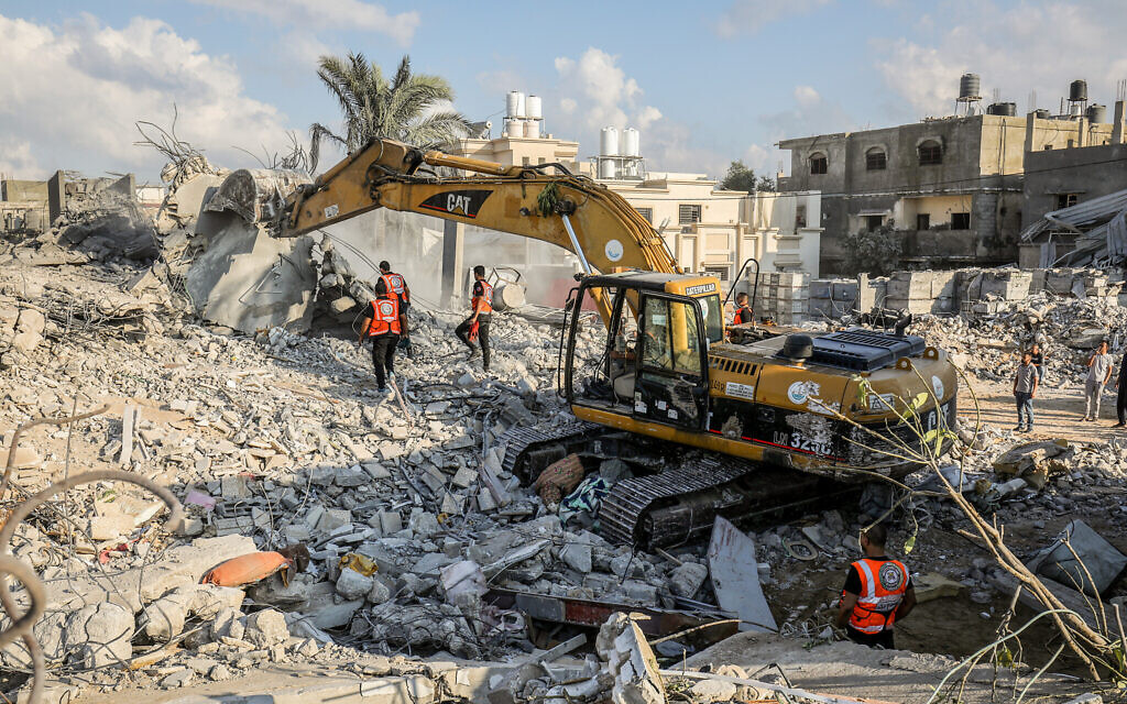 Palestinian civil defense and medical teams search the rubble after an Israeli airstrike on the Rafah refugee camp in the southern Gaza Strip, October 16, 2023. (Abed Rahim Khatib/Flash90)