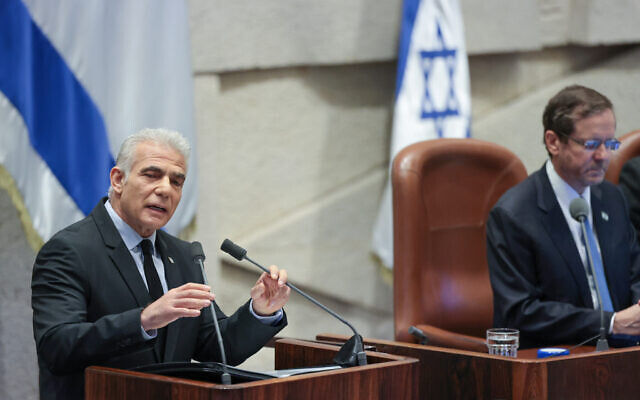 Opposition Leader Yair Lapid speaks at the opening session of the Knesset's winter session, in the Knesset plenum in Jerusalem, October 16, 2023. (Noam Revkin Fenton/Flash90)