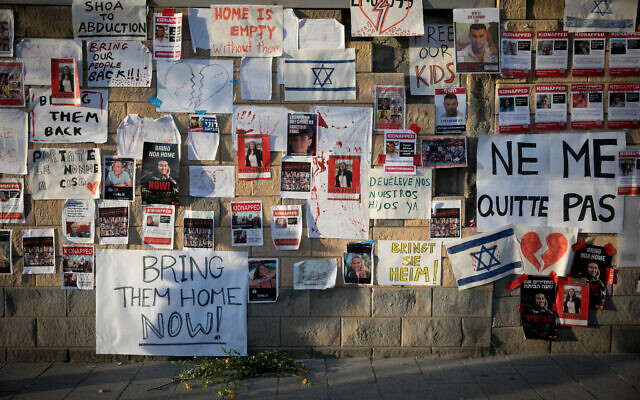 Posters calling for the release of hostages held by Hamas terrorists in Gaza, outside the Defense Ministry in Tel Aviv, October 21, 2023. (Miriam Alster/Flash90)