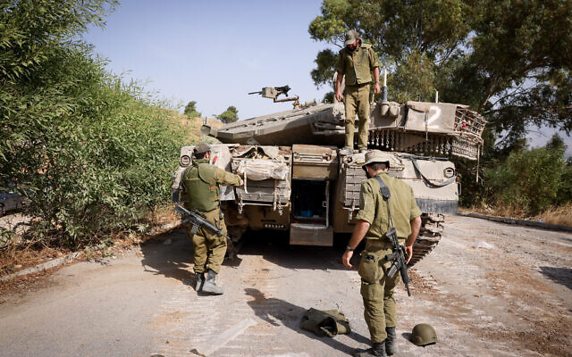 Israeli soldiers seen at a staging area near the Israeli border with Lebanon, northern Israel, October 22, 2023. (David Cohen/Flash90)