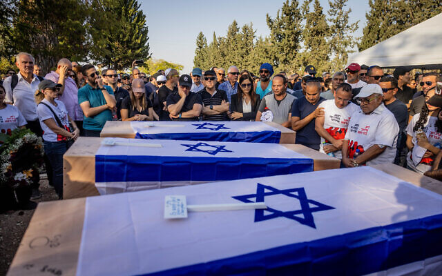 Family and friends attend the funeral of three members of the Sharabi family, Lian, Noya and Yahel, who were murdered by Hamas terrorists in Kibbutz Be'eri on October 7, 2023, in Moshav Kfar HaRif, southern Israel, October 25, 2023. (Chaim Goldberg/Flash90)