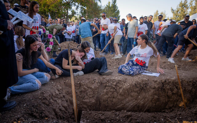 Family and friends attend the funeral of three members of the Sharabi family, Lian, Noya and Yahel, who were murdered by Hamas terrorists in Kibbutz Be'eri on October 7, 2023, in Moshav Kfar HaRif, southen Israel, October 25, 2023. (Chaim Goldberg/Flash90)