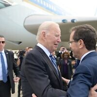 File - US President Joe Biden embraces President Isaac Herzog upon landing in Israel on October 18, 2023. (Isaac Herzog/X)