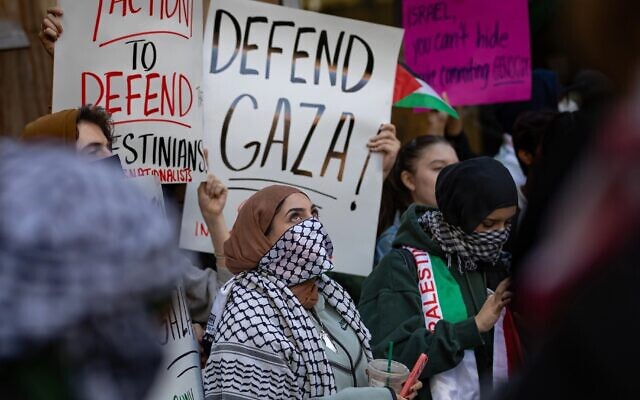 Illustrative: Students from Hunter College in New York City chant and hold up signs during a pro-Palestinian demonstration at the entrance of their campus on October 12, 2023. (Michael Nigro/Pacific Press/LightRocket via Getty Images, via JTA)