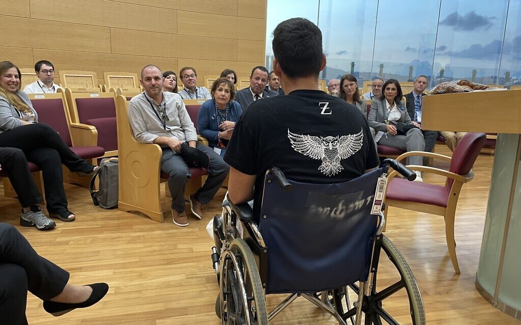 Itai, a soldier in the special forces of the IDF's Nahal Brigade, tells a visiting delegation from the Conference of Presidents of Major Jewish Organizations about his fight with Hamas terrorists who infiltrated Israel on October 7, 2023. Hadassah Medical Center, October 19, 2023. (Renee Ghert-Zand/TOI)