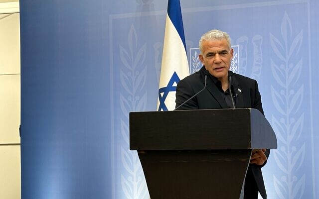 Opposition Leader Yair Lapid speaks to media in Tel Aviv on October 19, 2023 (Carrie Keller-Lynn/Times of Israel)