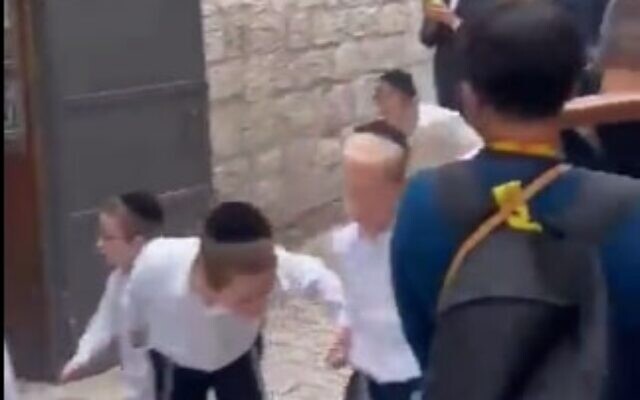 Orhtodox Jews filmed spitting at Christian tourists in the Old City of Jerusalem on October 2, 2023. (Screen capture/Twitter)