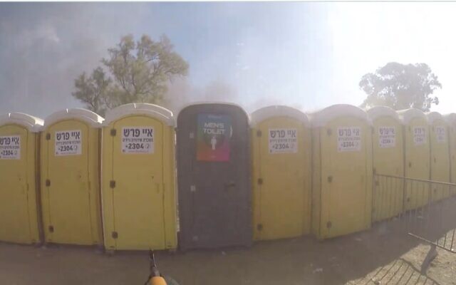 Hamas terrorists fire at Israelis hiding in port-o-potties near Re'im in southern Israel on October 7, 2023. (South First Responders)