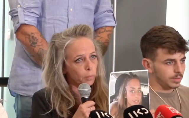 Keren Schem, with Mia's brother and a photo of Mia, held hostage in Gaza, at a press conference on October 17, 2023 (Facebook Live screen shot)
