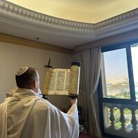 A member of Communications Minister Shlomo Karhi's delegation holds up a Torah scroll during a morning prayer service in Riyadh, Saudi Arabia, October 3, 2023. (Spokesman's Office, Communications Ministry)