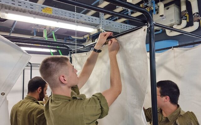 Soldiers help prepare the Sammy Ofer Fortified Underground Emergency Hospital at Rambam Medical Center in Haifa following the outbreak of war, October 11, 2023. (Courtesy of Rambam)