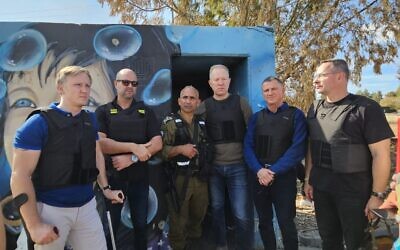Outside of bunker in which Re'im musical festival attendees were murdered by Hamas stand: Latvian MP Rihards Kols, Knesset Speaker MK Amir Ohana, IDF Col (Res) Golan Vach, Estonian MP Marko Mihkelson, MK Yuli Edelstein, Lithuanian MP Žygimantas Pavilionis, October 17, 2023. (Courtesy: MK Yuli Edelstein)
