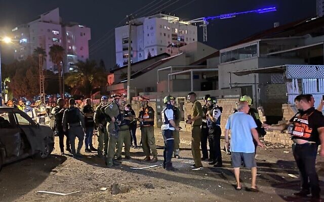 People gather at the site of a rocket impact in the souther port city of Ashdod, October 28, 2023. (Courtesy(