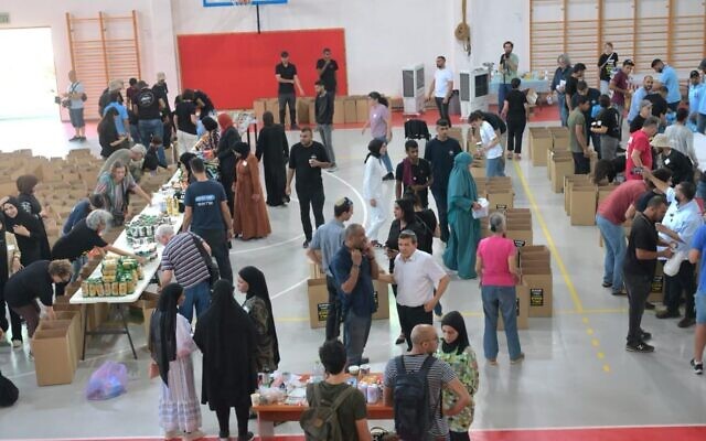 Volunteers at the Rahat community center sorting goods and creating packages, October 2023. (courtesy)