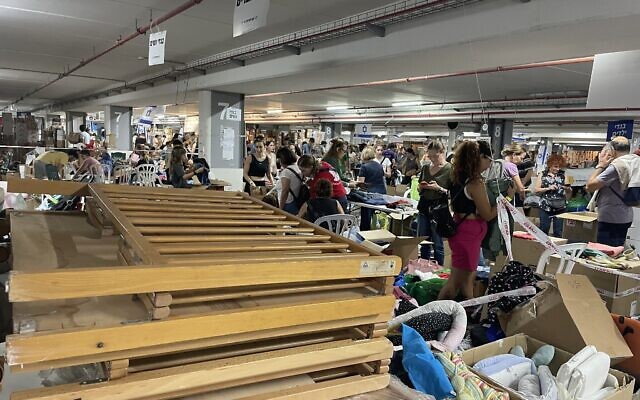 Volunteers help to sort and pack donated equipment to be sent to evacuees all over the country at the Civilian Operations Hub, Expo Tel Aviv, October 19, 2023. (Sue Surkes/Times of Israel)
