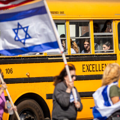 Illustrative: Children watch through the window of a school bus as demonstrators attend a rally in solidarity with Israel on October 10, 2023 in Los Angeles, California. (Photo by Ethan Swope / GETTY IMAGES NORTH AMERICA / Getty Images via AFP)