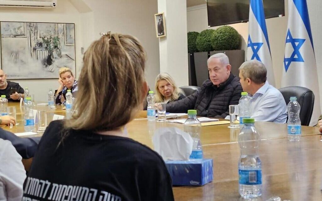 Prime Minister Benjamin Netanyahu, his wife Sara at his side, meets with representatives of families whose loved ones are being held hostage by Hamas in the Gaza Strip, October 28, 2023. (GPO)