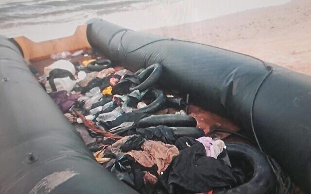 An rubber dingy with no one on board buy carrying identity papers of foreign nations that washed up on the shore near Nahariya, October 1, 2023. (Israel Police)