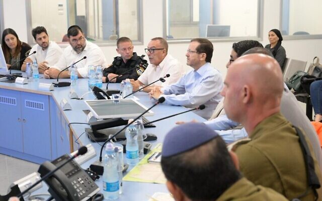 President Isaac Herzog (center right) at a Netivot council meeting, October 17, 2023 (Amos Ben Gershom / GPO)
