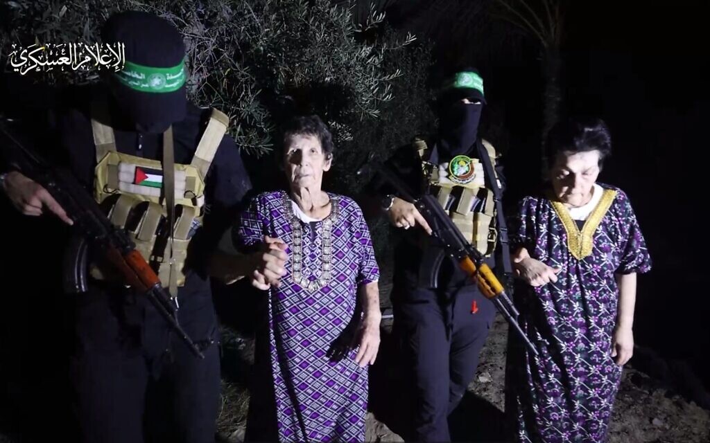 A still from a video released by Hamas's armed wing showing hostages Yocheved Lifshitz, left, and Nurit Cooper before their release from captivity, October 23, 2023. (screen capture)