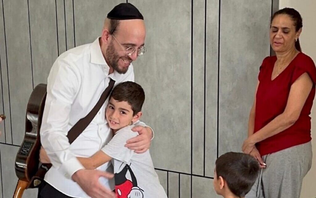 Pini Einhorn hugs a child at a shiva in Israel in October 2023. (Courtesy: Pini Einhorn)