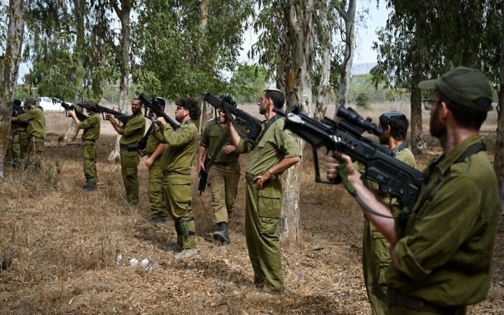 Israeli Infantry reservists seen during a light arms training in northern Golan Heights before heading south to the Gaza Strip on October 8, 2023. (Michael Giladi/Flash90)