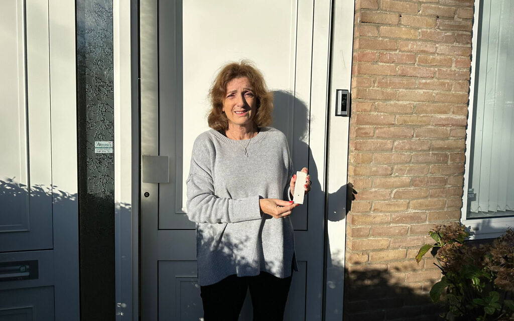 Marja Goldstoff holds the Camozuzah at the entrance to her home in Amsterdam, the Netherlands on October 31, 2023. (Courtesy)